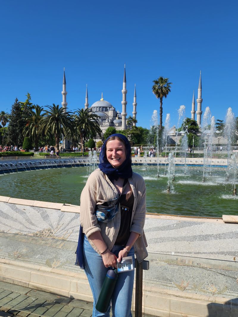 Macy standing in front of a fountain in Türkiye.