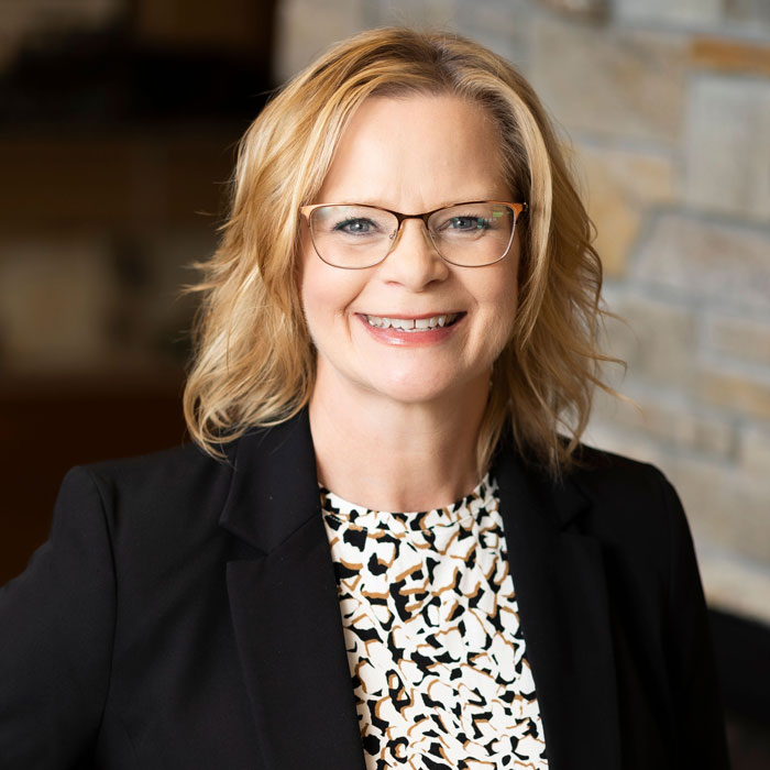headshot of audrey boehm wearing a black blazer and white shirt