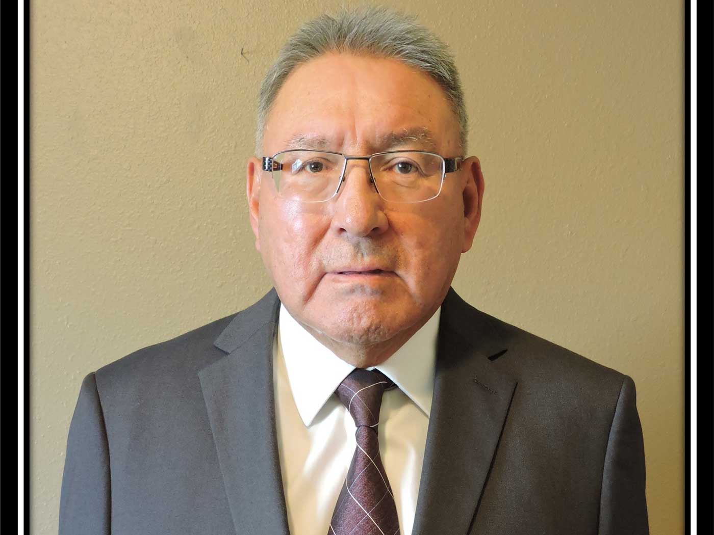 native american man in front of wall