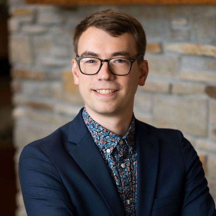 headshot of bailey ellis wearing blue suit