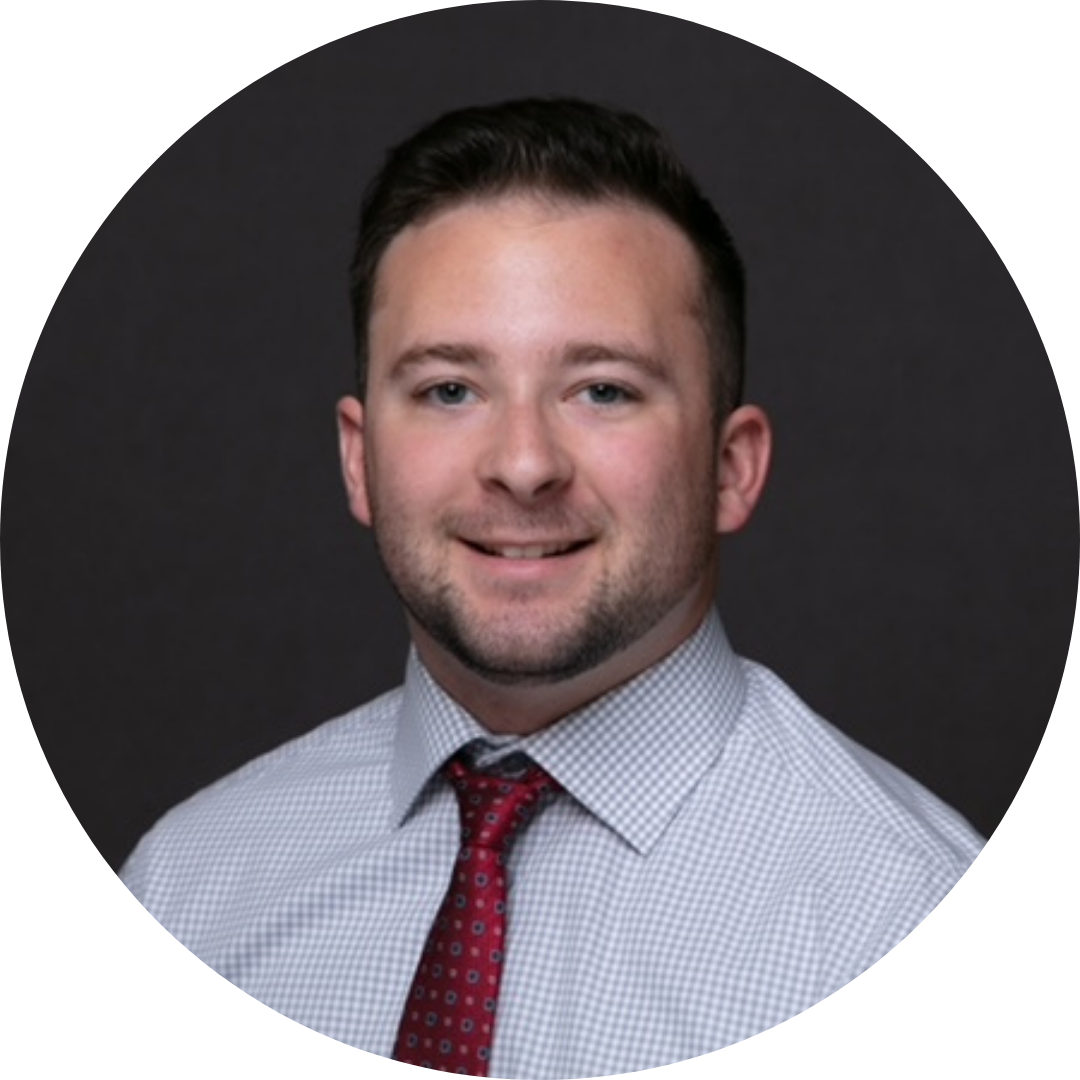 headshot of ryan bozer wearing a tan blazer and brown shirt