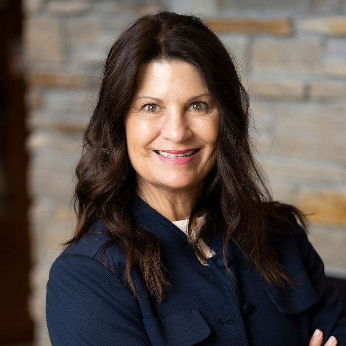 headshot of michelle chikos wearing a blue blazer