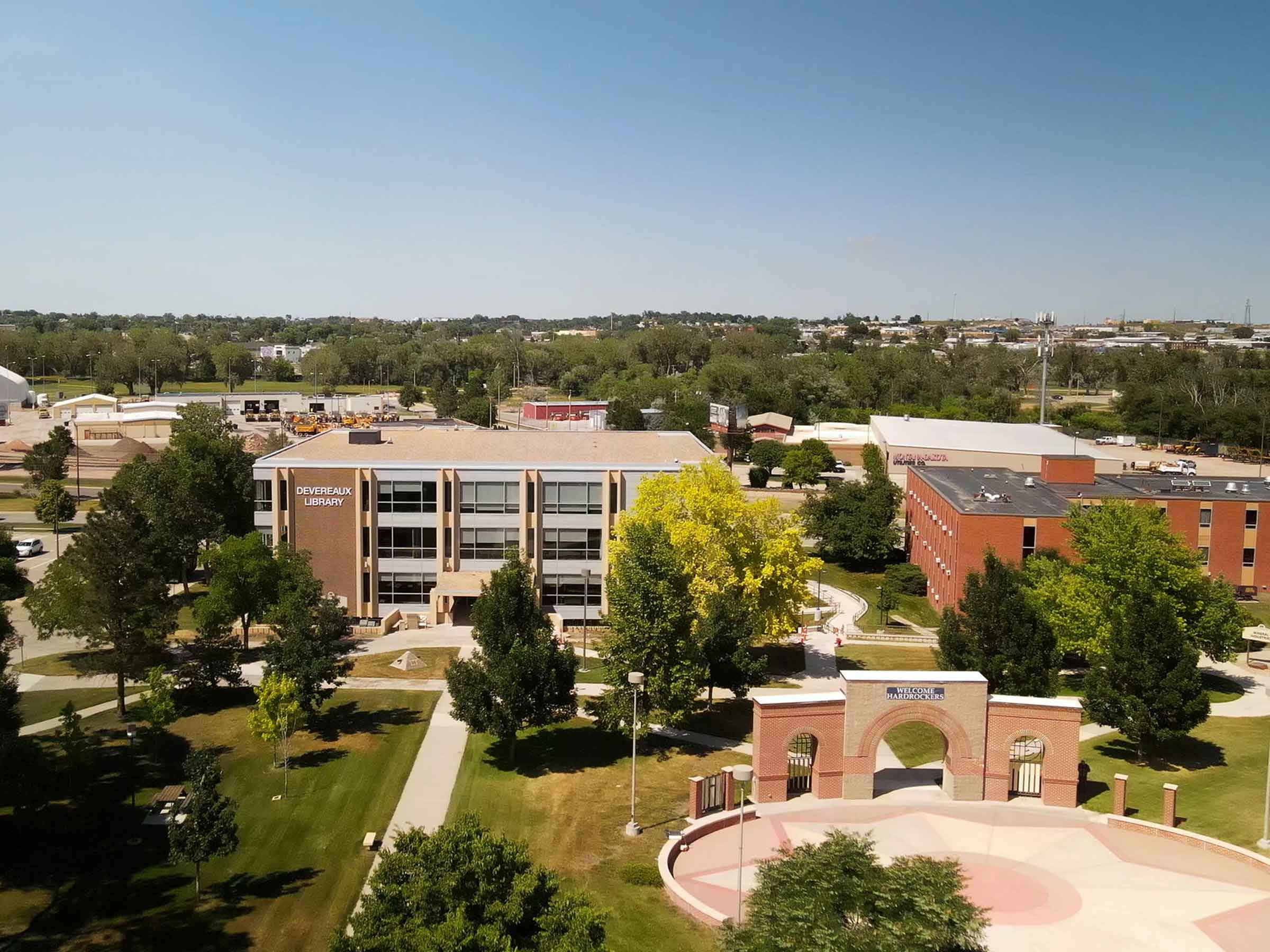 aerial-library-arch-hero aerial image of a college quad with the library in the background and the brick archway in the foreground