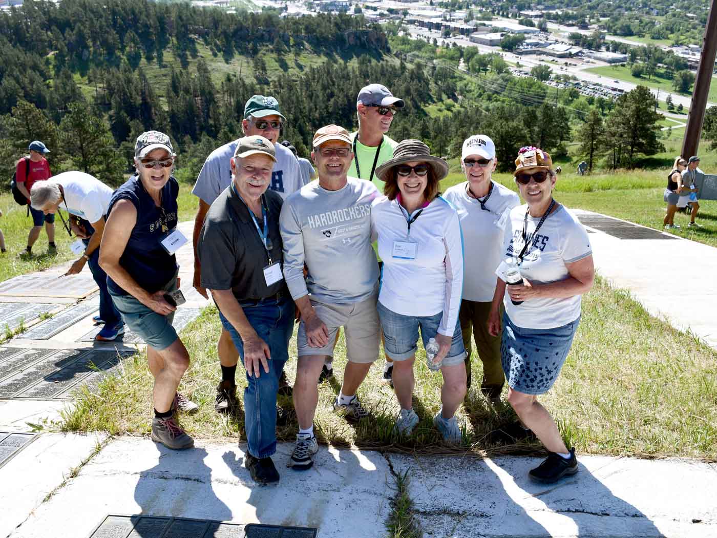 smiling group of people standing on m hill