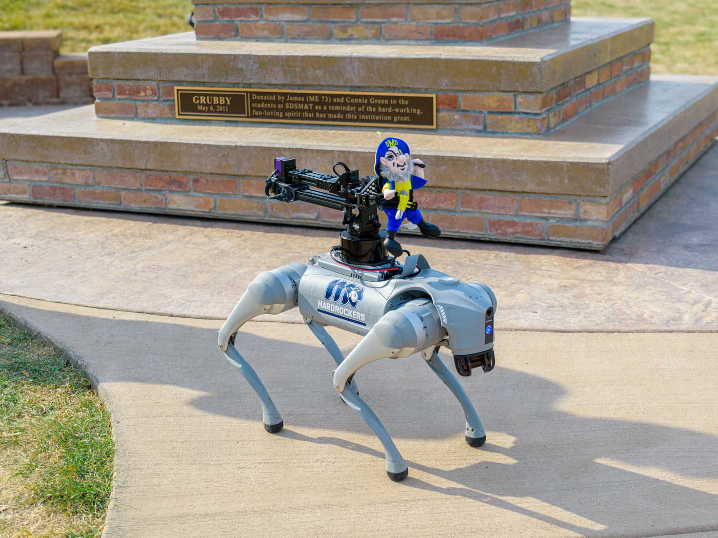 astro-robot-dog-web robotic dog with miner stuffed person sitting on top