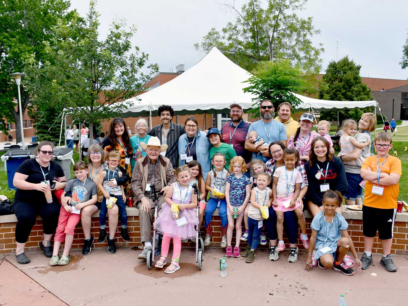 large group of people and kids at reunion in campus quad